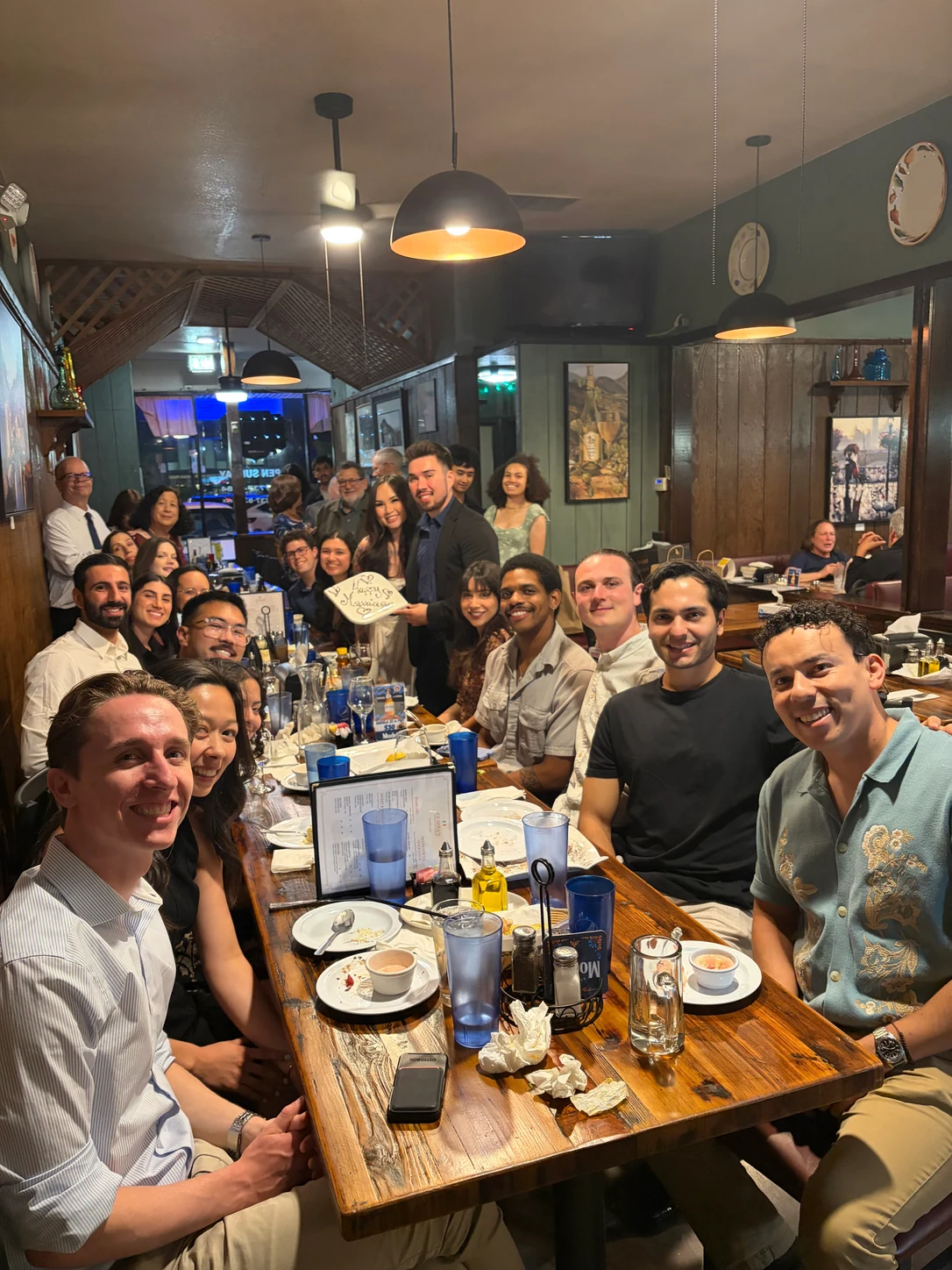Friends gathered around a long table at Gumba’s.