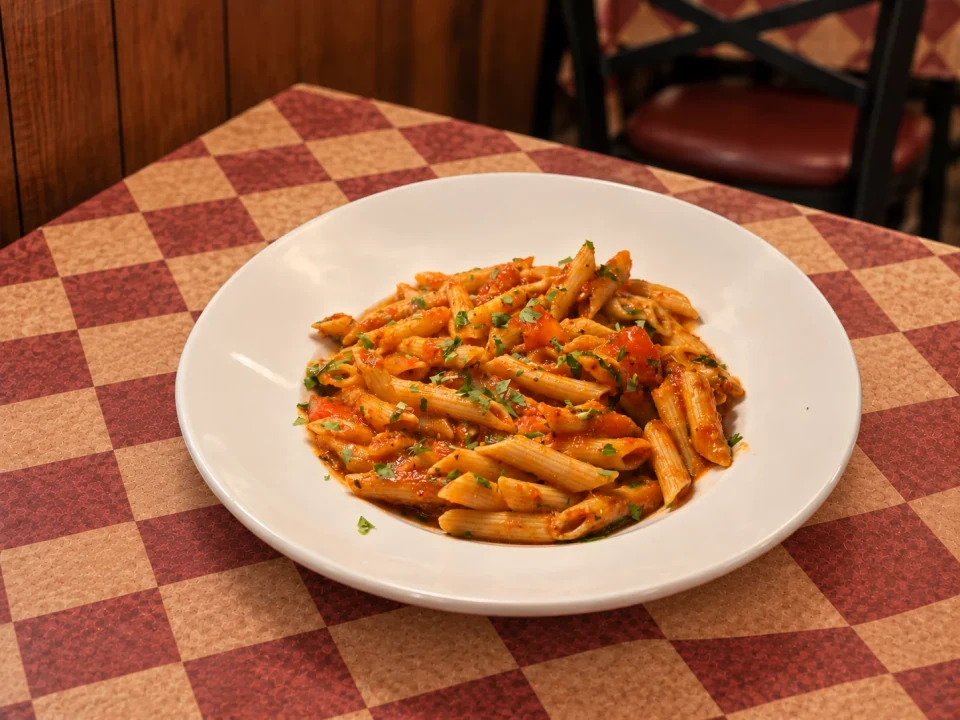 Penne on Gumba’s patterned table. AI-assisted image.